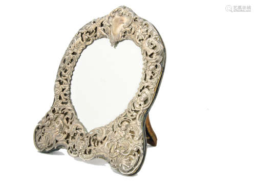 An Edwardian silver fronted mirror, possibly by William Comyns, with heart shaped mirror panel and