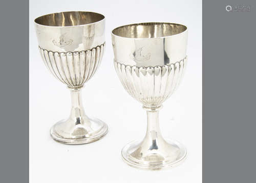 Two Victorian silver trophy goblets, one marked London 1875, with half fluted bowls on socle