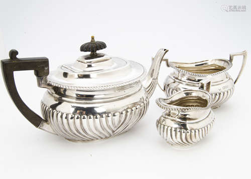 A late Victorian three piece silver tea set by Henry Wilkinson & Co, London 1899, fluted lower