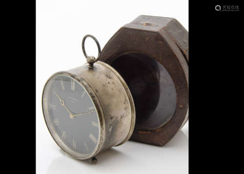 An early 20th century silver plated travel clock from Bryson's Paris, circular case with black dial,