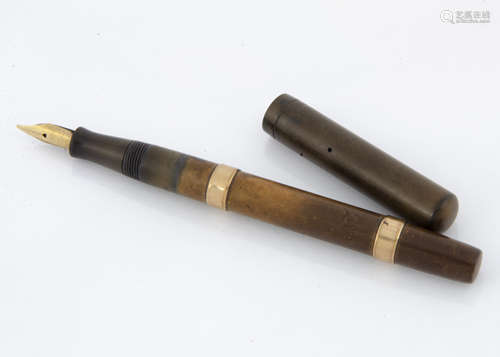 An Edwardian Watermans Ideal fountain pen, light brown barrel with two 9ct gold mounts, with brown