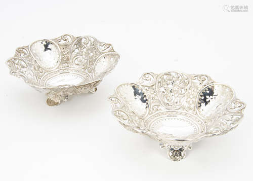 A pair of Victorian silver bon bon dishes by GT & Co, having raised and pierced decoration,