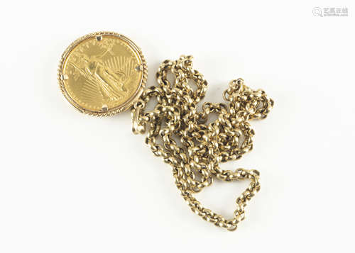 A 1990s US gold fifty dollar coin, mounted in a 14k marked pendant surround with a belcher link