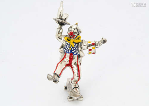 A modern silver and enamelled clown from Mappin & Webb, modelled standing on one leg on a skatebaord