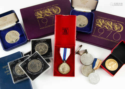 A small collection of coins and medals, including a 1937 crown, other modern cupro-nickel crowns,