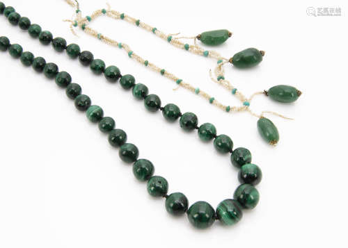 A malachite graduated bead necklace, with rough pebble shaped stones, 57cm long together with a seed