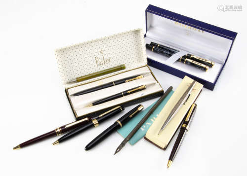 A small group of pens, including a modern Waterman fountain pen and roller ball set in a box, a
