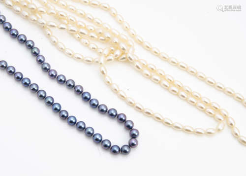 A string of Tahitian black cultured pearls, on a 14ct gold clasp, 47cm, and two strings of