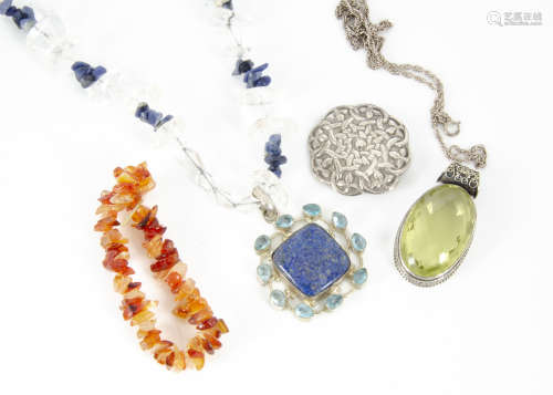 A collection of various costume jewels, including a silver brooch, a lapis lazuli, rock crystal
