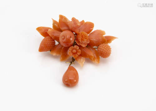 A 19th Century Italian coral brooch, the floral and fruit carved coral surmounted by a small