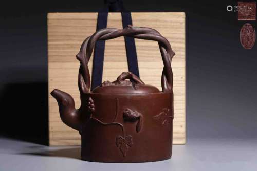 A Chinese Red Pottery Hoop-handled Kettle