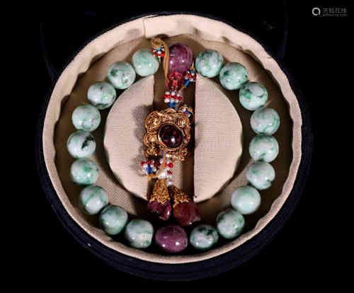 A Chinese Bracelet of 18 Emerald Jade Balls