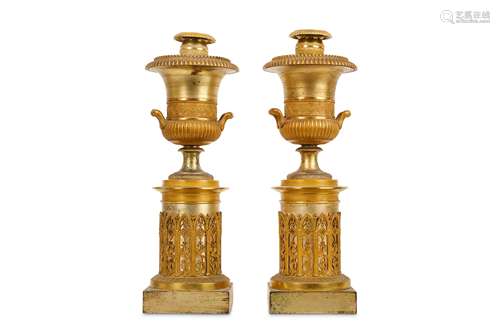 A PAIR OF SECOND QUARTER 19TH CENTURY FRENCH GILT AND SILVERED BRONZE CANDLESTICKS FORMED AS URNS