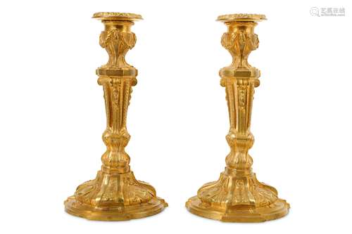 A PAIR OF LATE 19TH CENTURY FRENCH GILT BRONZE CANDLESTICKS IN THE LOUIS XVI STYLE formed as