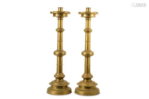 A PAIR OF LATE 19TH CENTURY ENGLISH BRONZE CHURCH CANDLESTICKS IN THE MANNER OF PUGIN the circular