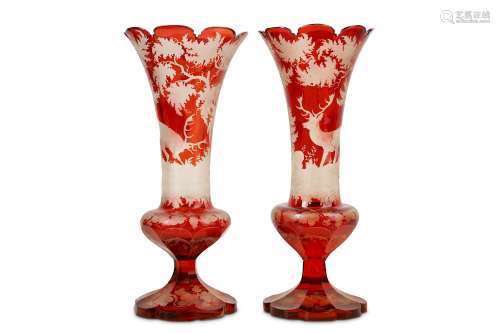 A PAIR OF 19TH CENTURY BOHEMIAN RUBY GLASS VASES of trumpet form, with scallop edge rims, the bodies