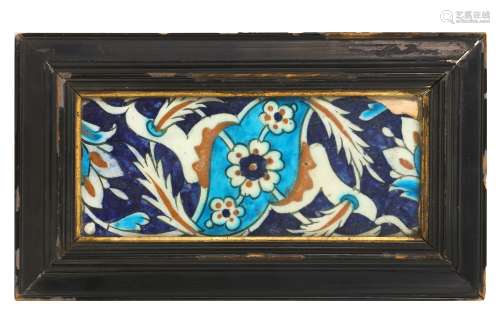 A 17TH CENTURY TURKISH OTTOMAN IZNIK GLAZED POTTERY TILE of rectangular form, decorated with blue,