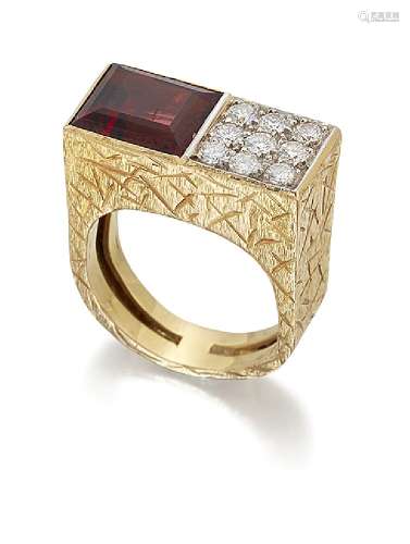 An 18ct gold, garnet and diamond ring by Andrew Grima, the textured geometric band collet-set to the