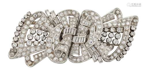 A diamond double clip brooch, the opposed twin panels of ribbon scroll design set throughout with