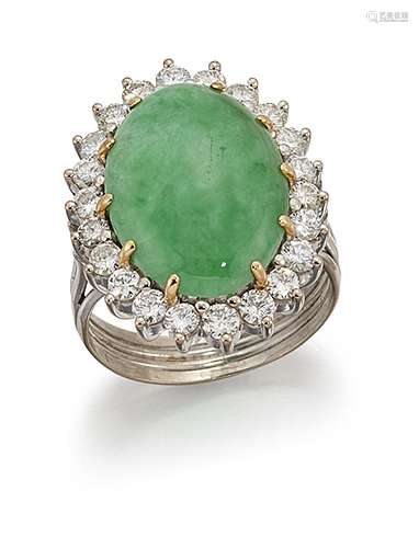 A jadeite jade and diamond cluster ring, the oval jade cabochon within a brilliant-cut diamond