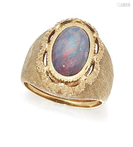 An opal ring by Buccellati, the central oval black opal within a scalloped surround to a textured