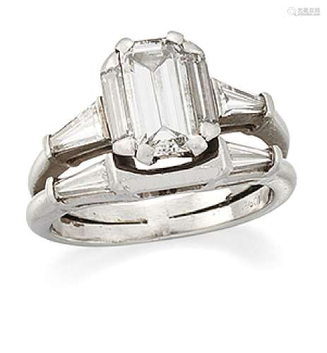 A diamond ring, composed of conjoined hoops, one with cut-cornered rectangular diamond single single