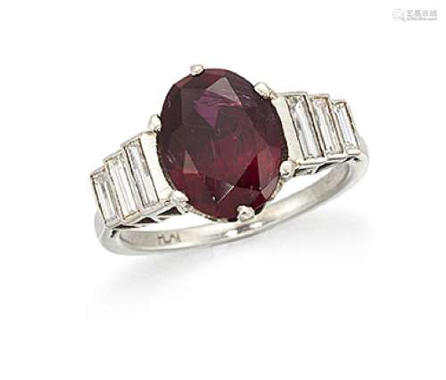 A platinum, ruby and diamond ring, the single claw-set oval-cut ruby with baguette diamond three