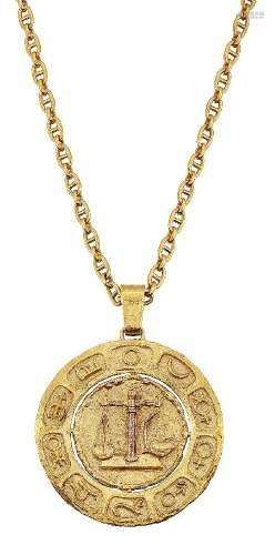 An 18ct gold Zodiac pendant by Leo De Vroomen, the circular textured pendant with central symbols