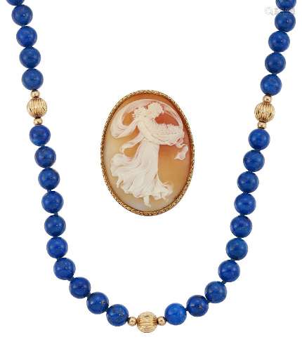 An early 20th century shell cameo brooch and a lapis lazuli necklace, the oval shell carved to