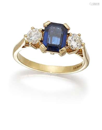 A sapphire and diamond three stone ring, the cut-cornered rectangular sapphire between brilliant-cut
