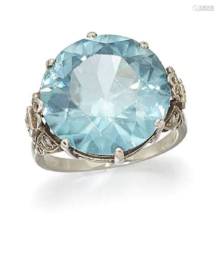 A zircon and diamond ring, the circular-cut blue zircon to single-cut diamond tapered shoulders,