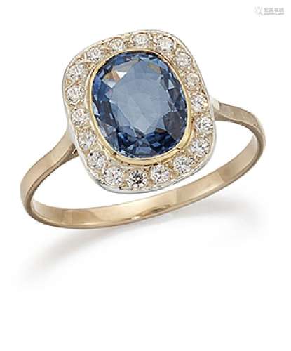 A sapphire and diamond cluster ring, the oval sapphire single stone collet centre within a