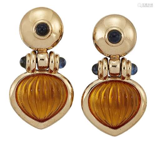 A pair of citrine and sapphire earclips, the pear shaped reeded cabochon citrine drops to hinged
