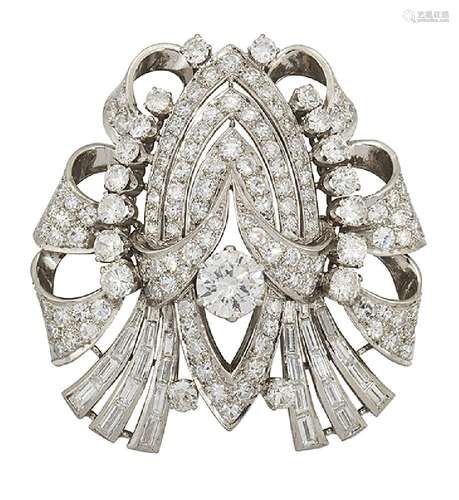 A diamond brooch, the circular, single and baguette-cut diamond symmetrical openwork panel of scroll