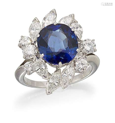A sapphire and diamond cluster ring, the central oval sapphire in claw mount with marquise and