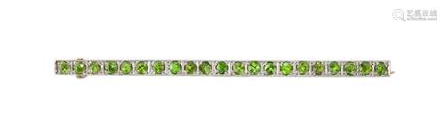 An Edwardian demantoid garnet brooch, composed of a line of circular-cut demantoid garnets,