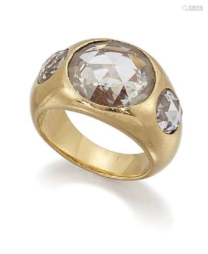 A rose cut diamond three stone gypsy ring, the central circular rose-cut diamond within a broad