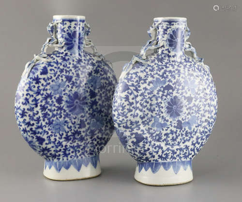 A pair of Chinese blue and white moonflasks, 19th century, each painted with lotus flowers and