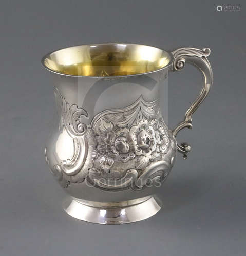 A George III Irish silver mug by Matthew West, of baluster form, with later? embossed foliate and