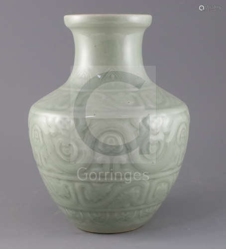 A Chinese celadon glazed archaistic moulded vase, Qianlong underglaze blue seal mark to base,