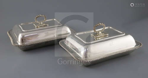 A pair of George V silver entree dishes, cover and handles, by Harrods Stores Ltd, of rectangular