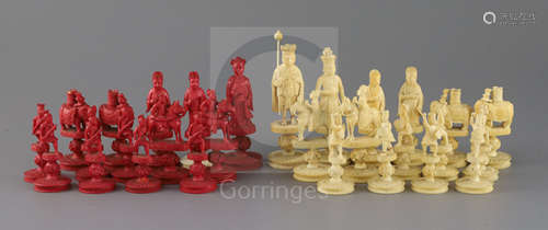 An early 19th century Chinese red stained and natural ivory 'rosette' type chess set, modelled as