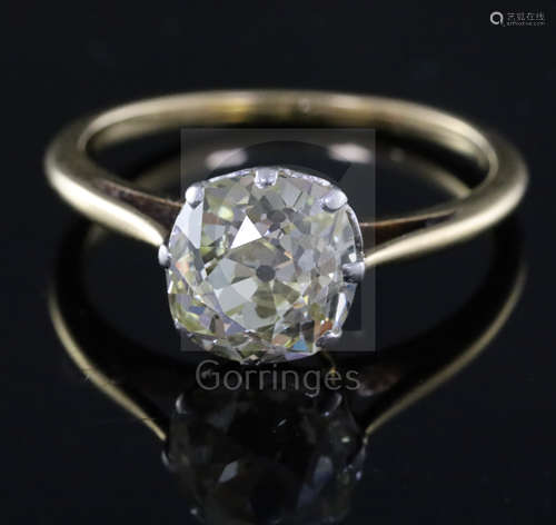 A gold and old mine cut solitaire diamond ring, the stone measuring approximately 8.5mm by 8.3mm,