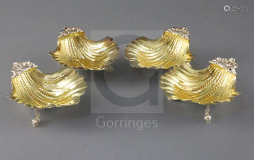 A set of four George III silver shell shaped table salts, by George Hall?, with shell thumbpiece and