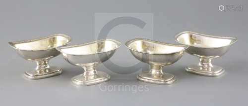 A set of four George III Irish silver pedestal salts by James Scott, of rounded rectangular form,