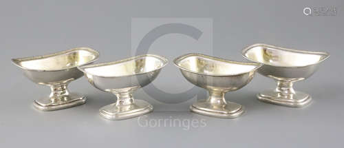 A set of four George III Irish silver pedestal salts by James Scott, of rounded rectangular form,