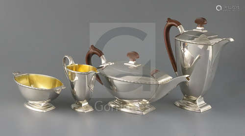 A George VI Art Deco silver four piece pedestal tea set by Adie Brothers, of shaped rounded