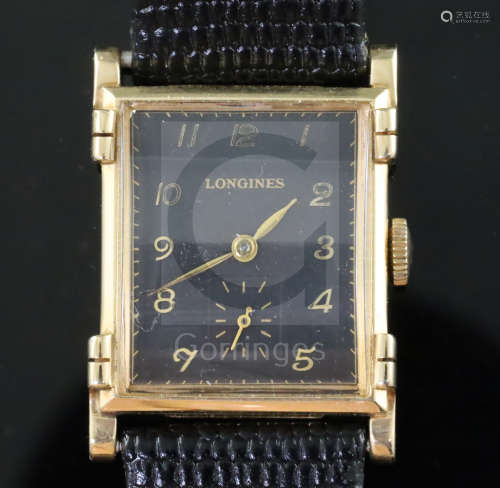 A gentlemans stylish 1930's 14k gold Longines manual wind wrist watch, with raised lugs and