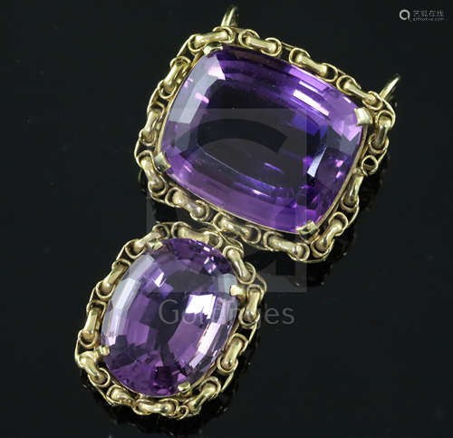 A gold and two stone amethyst set drop pendant, the oval cushion and round cut stones with ornate