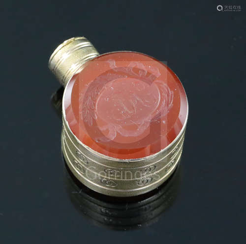 A small 19th century engraved gold and carnelian set moon shaped scent flask, one carnelian carved